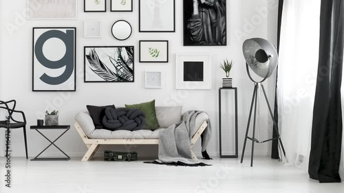 Wind blowing in stylish living room with black and white curtains
