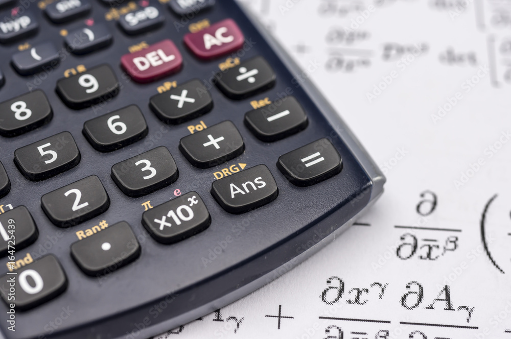 Close up shot of scientific calculator and mathematical equations sheets Close up shot of scientific calculator and mathematical equations sheets