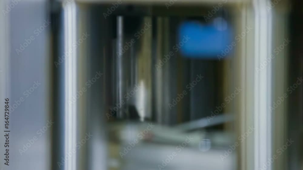 Automatic machinery is pressing down every fewseconds when an item is moving down a conveyor belt. Automatic machinery is pressing down every fewseconds when an item is moving down a conveyor belt.
