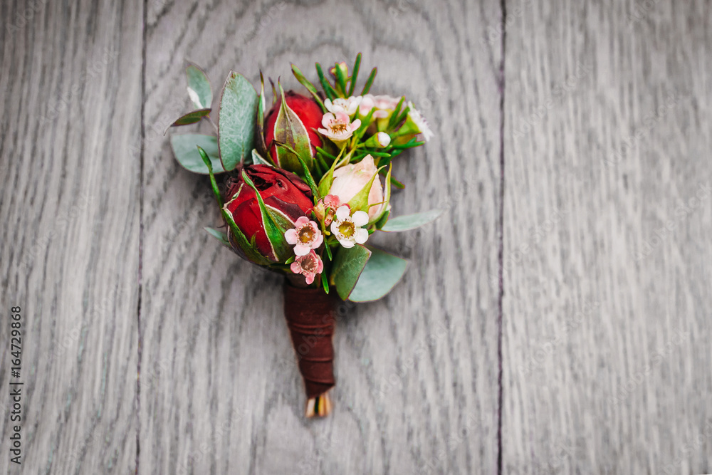 Boutonniere groom on a gray wooden background Boutonniere groom on a gray wooden background
