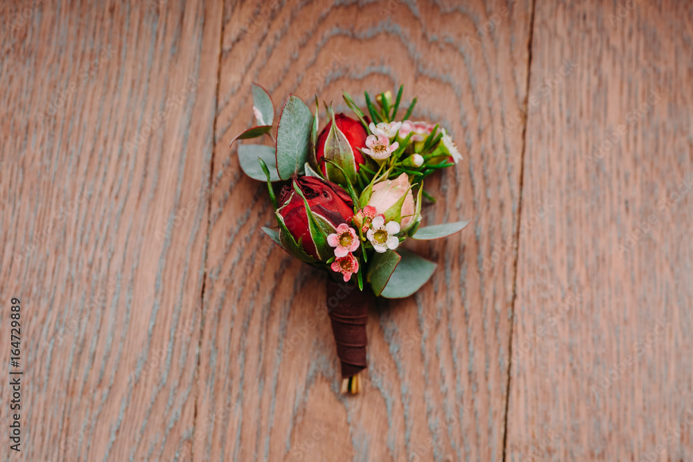 Boutonniere groom on a wooden background Boutonniere groom on a wooden background