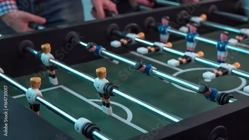 Wallpaper Mural A few employees are having a break and they are playing table football in the office to relax a bit.  Torontodigital.ca