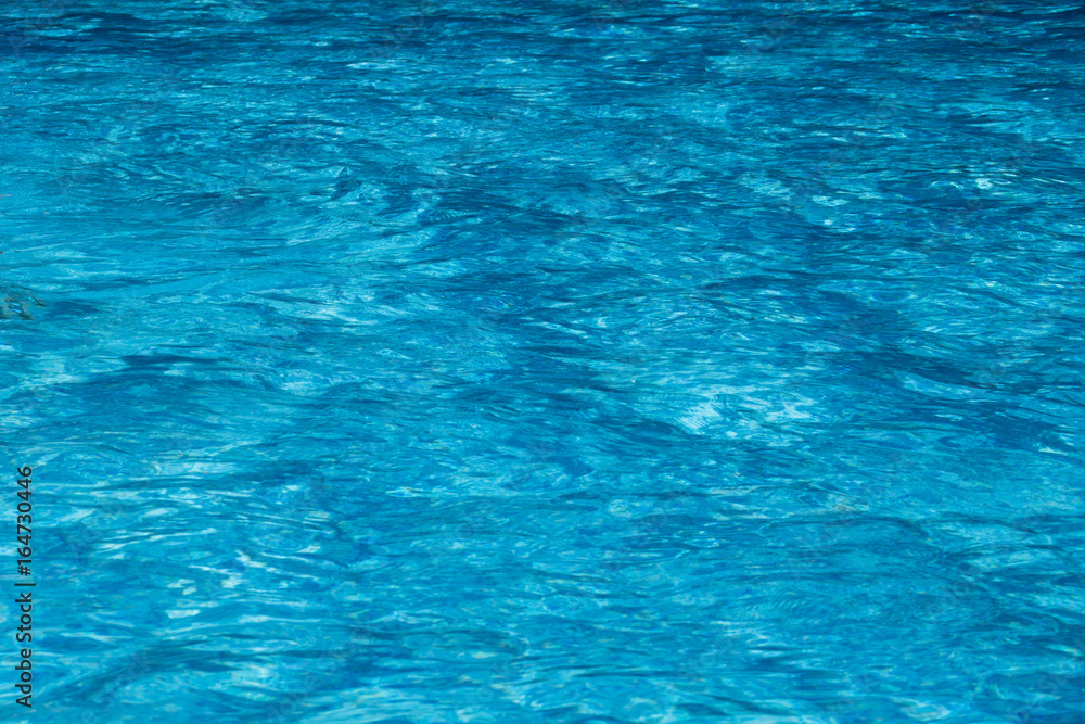 Texture of water of the pool is blue. Textural background