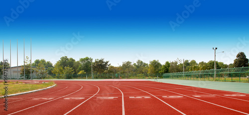 Running track with lanes over sky and clouds