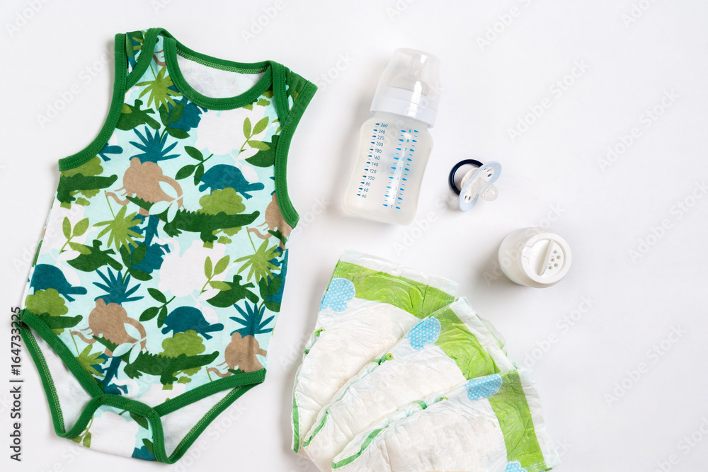 Babies goods diaper, baby powder, cream, shampoo, oil on white background with copy space. Top view or flat lay. Babies goods diaper, baby powder, cream, shampoo, oil on white background with copy space. Top view or flat lay.