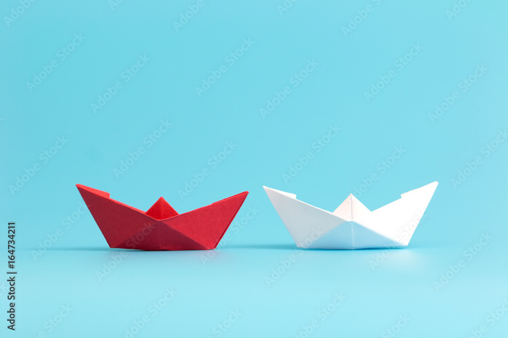Two paper boats competing. Business competition concept. Minimal style. Two paper boats competing. Business competition concept. Minimal style.