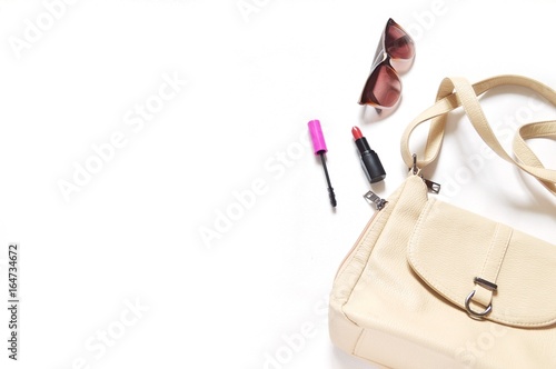 Flat lay fashion mockup/ Beige ladies bag, mascara, red lipstick and brown sunglasses. Style, image. Free space for text