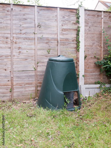 a green compost bin outside in garden