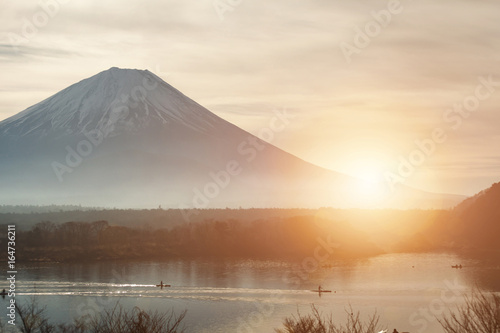 beautiful twilight and sunset landscape of mt Fuji, Japan, a small lake with people boating in the front