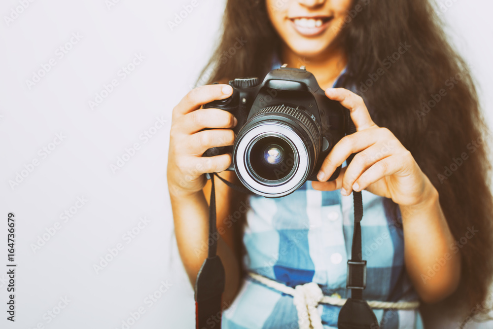 Cute brunette little girl holding an photo camera, isolated on white background Cute brunette little girl holding an photo camera, isolated on white background