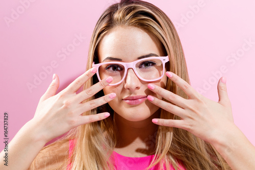 Beautiful young woman on a pink background