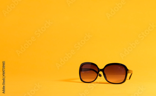 Big black sunglasses on a yellow background