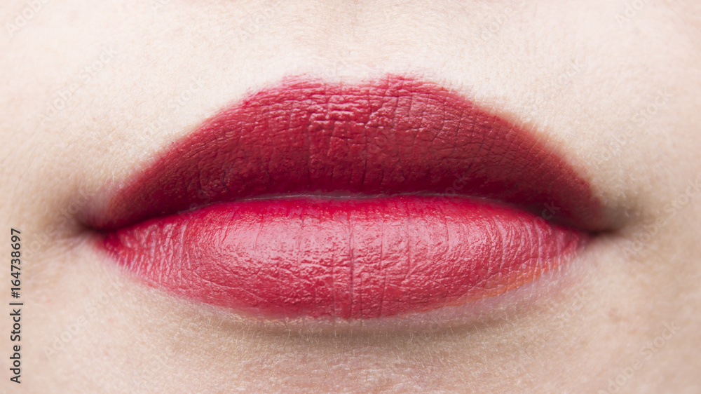 Fototapeta premium Asian girl lips are decorated with beautiful lipstick.