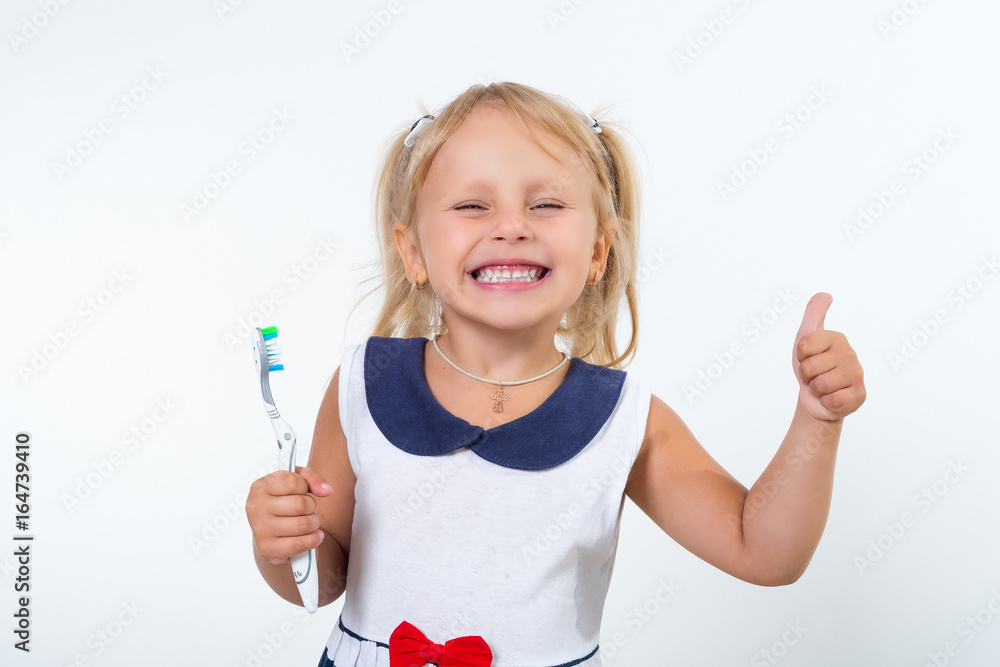 Little girl posing with a toothbrush.. Oral dental health, disease prevention. Positive face expression, emotion Little girl posing with a toothbrush.. Oral dental health, disease prevention. Positive face expression, emotion