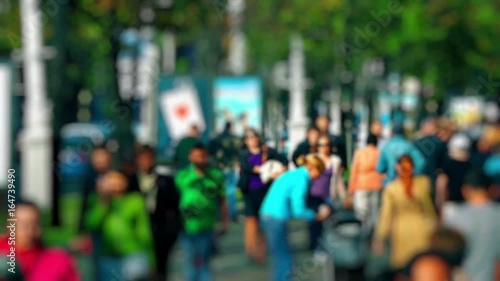 Wallpaper Mural Mother with stroller in crowd. Anonymous crowd on a busy street. People talking cellphones walk down a busy street with green trees on a hot summer day. Slow motion. Torontodigital.ca