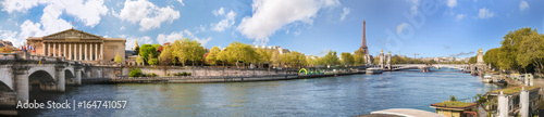 Panoramic view of Paris over river Seine with Alexander III bridge, Tour Eiffel and Assemblee Nationale