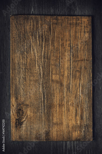 Old wooden board on a dark wooden background
