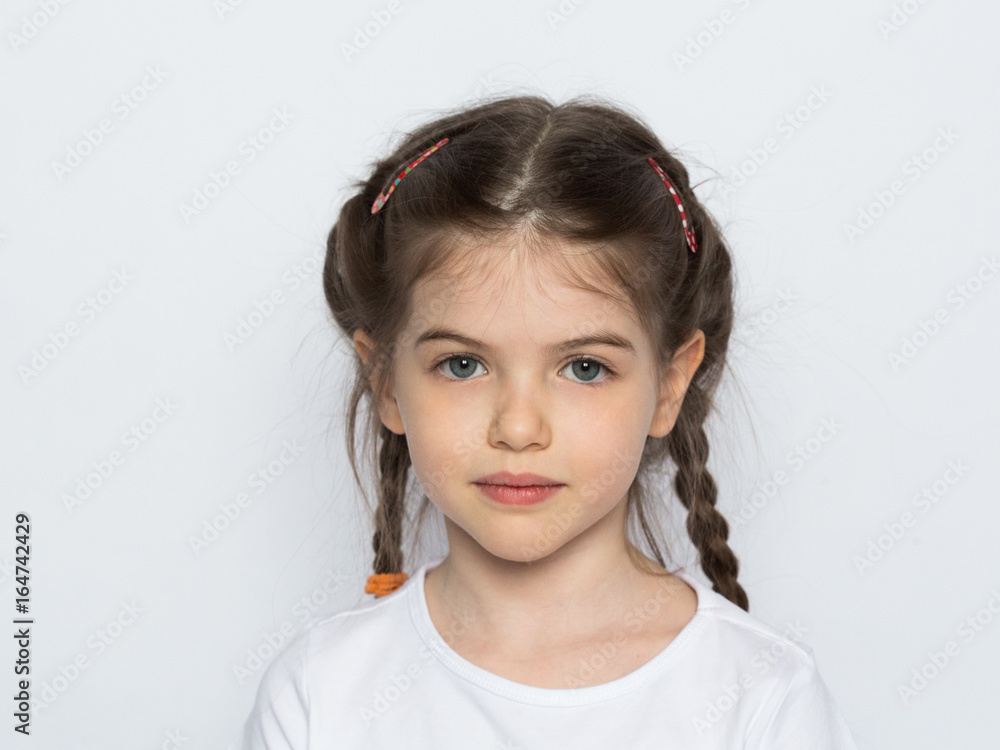 t-shirt design concept - little girl in blank white t-shirt, portrait on a white background t-shirt design concept - little girl in blank white t-shirt, portrait on a white background