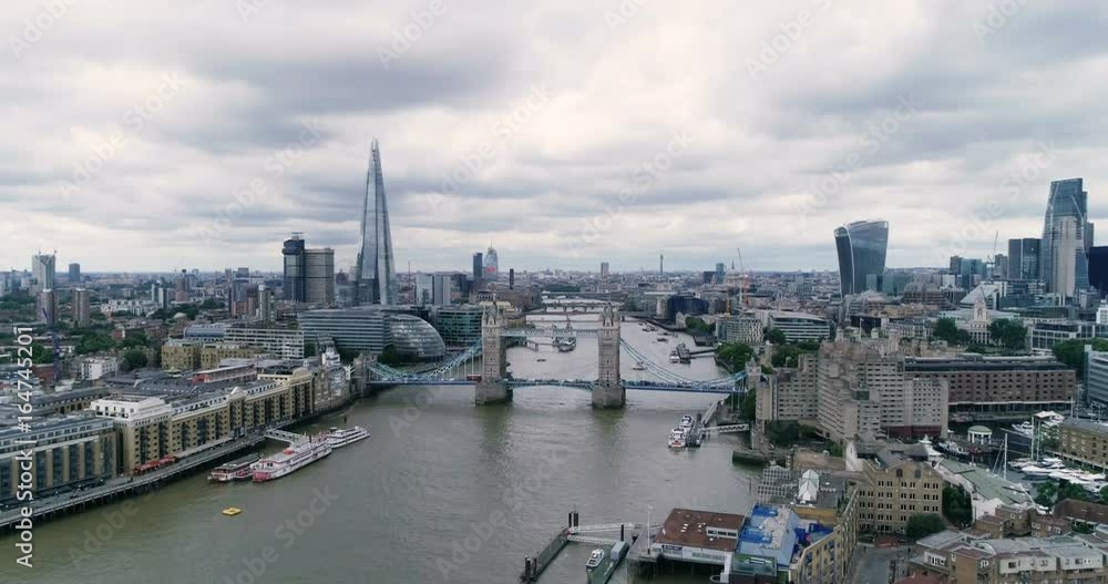 Aerial descending view of the skyline of the City of London with Tower bridge and the river Thames Aerial descending view of the skyline of the City of London with Tower bridge and the river Thames