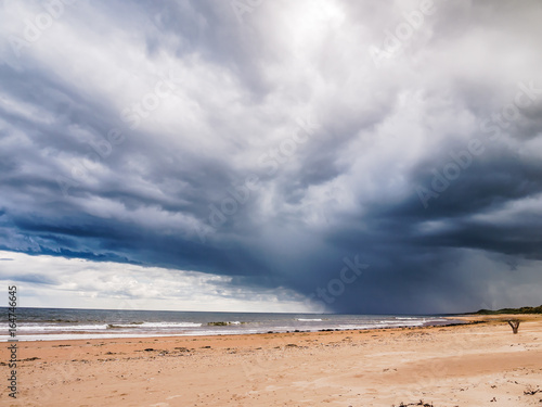 Storm clouds gathering above the beach of the 'Sands of Forvie' National Nature Reserve, Scotland, UK