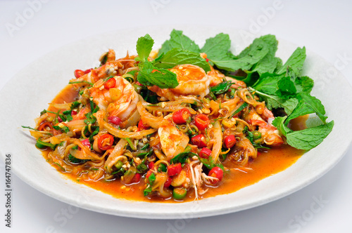Close-up shrimp salad with lemongrass and mint in white plate and white background