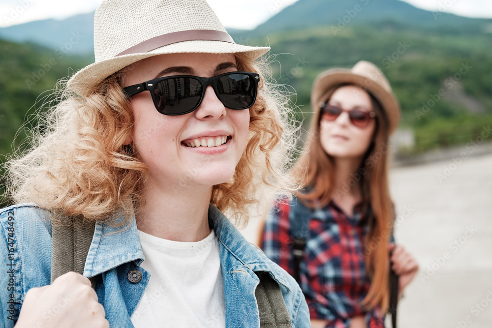 Two girls in hats traveling through ruins Two girls in hats traveling through ruins