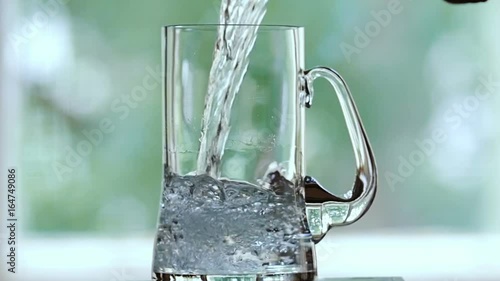 Water is poured into the beer mug.