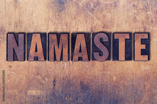 Fotografie Namaste Theme Letterpress Word on Wood Background