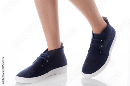 Man feet wearing blue fashion shoes in hipster style, step with side view, Isolated on white background, Men's Fashion concept.