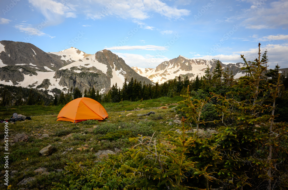 Orange Tent in Mountains with Trees, Snow in Indian Peaks Wilderness, Colorado