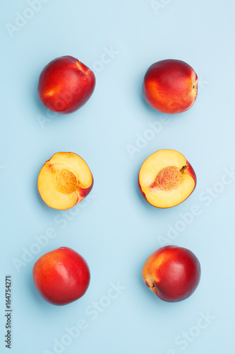A few ripe nectarines on a blue background