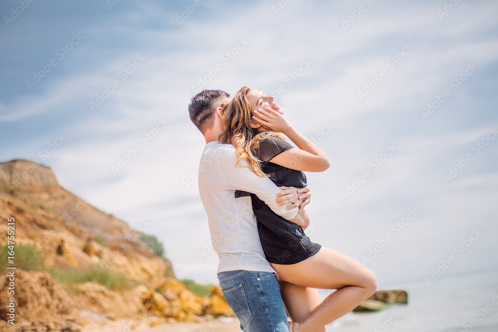 Beautiful Couple At Beach.Outdoor portrait happy beautiful couple,couple having fun by sea,enjoy vacation,trendy hipster look,happiness,love,summer holidays,man touching girlfriend,tan Beautiful Couple At Beach.Outdoor portrait happy beautiful couple,couple having fun by sea,enjoy vacation,trendy hipster look,happiness,love,summer holidays,man touching girlfriend,tan