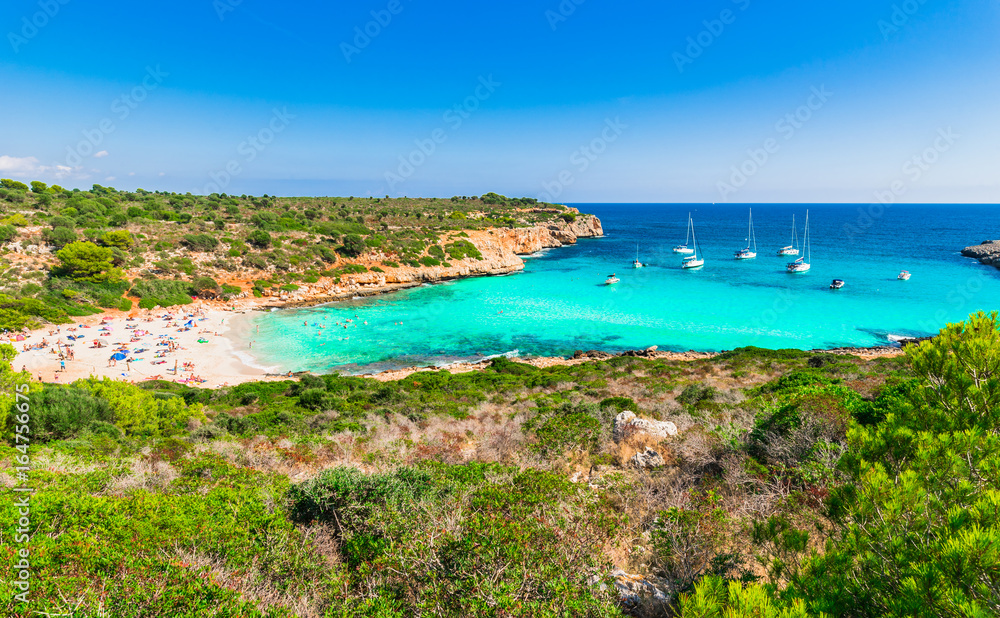 Cala Varques beautiful beach Majorca island, bay with tropical ocean water and sailboats, Spain Mediterranean Sea, Balearic Islands