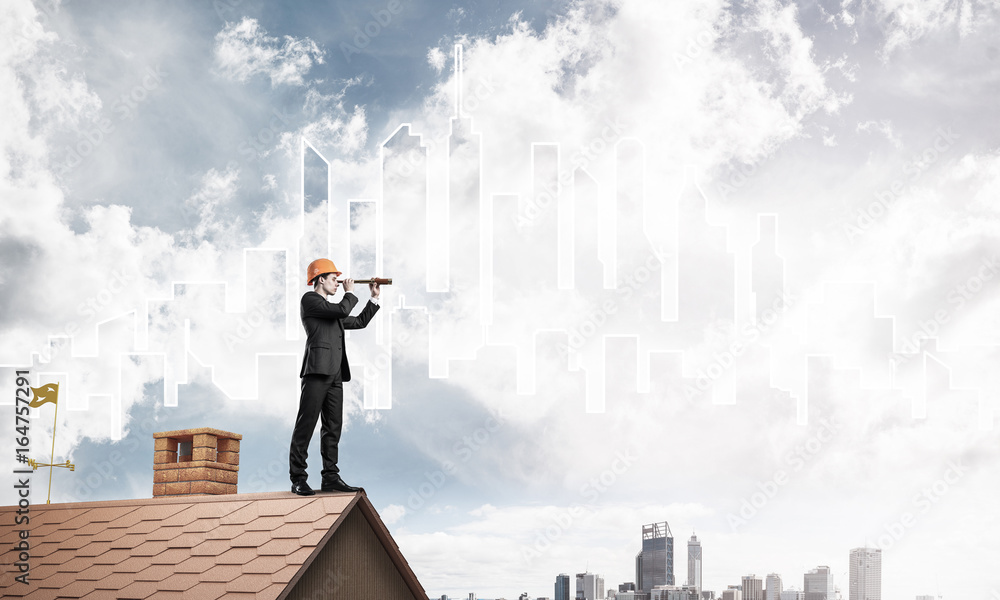 Engineer man standing on roof and looking in spyglass. Mixed med Engineer man standing on roof and looking in spyglass. Mixed med