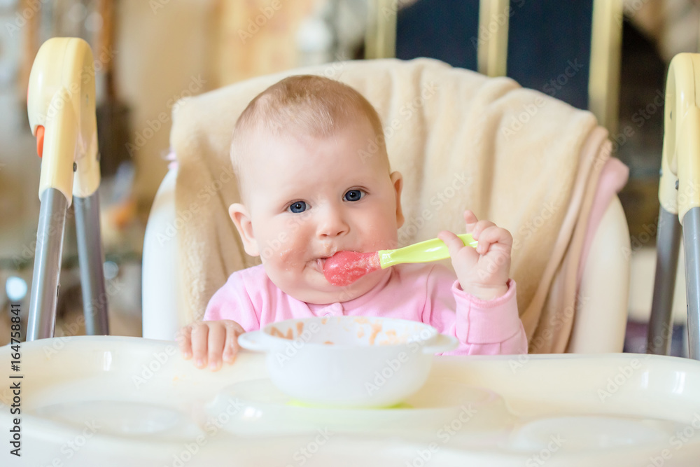 A cheerful happy child eats porridge. A cheerful happy child eats porridge.