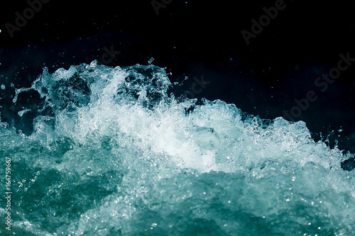 Fototapeta Naklejka Na Ścianę i Meble -  Splash of stormy water in the ocean on a black background