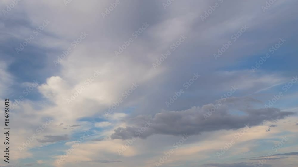 Russia, time lapse. Formation and rapid movement of white clouds of different shapes in the blue sky in late spring at sunset. Russia, time lapse. Formation and rapid movement of white clouds of different shapes in the blue sky in late spring at sunset.