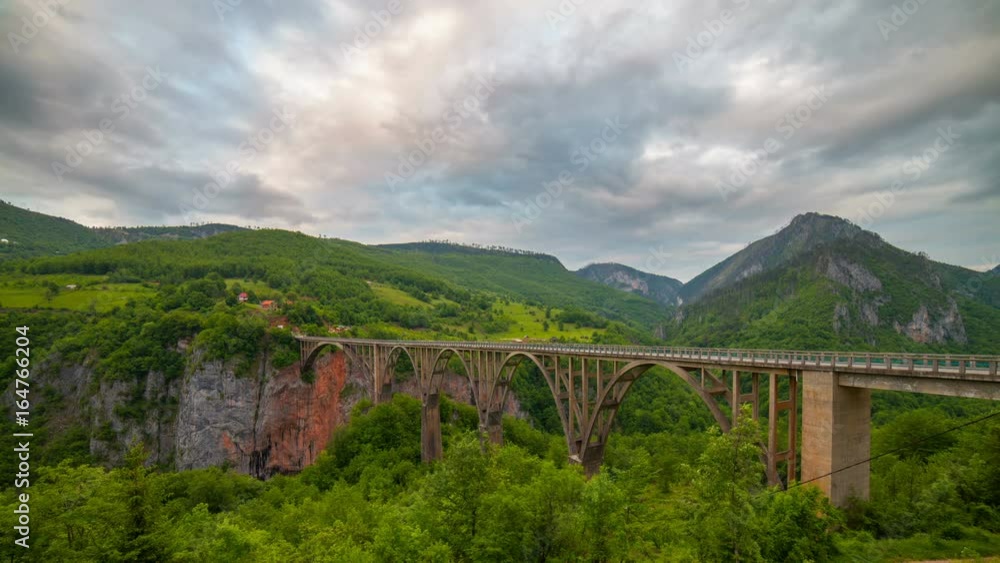 Timelapse video of Durdevica arched Tara Bridge over green Tara Canyon at evening time - Montenegro Timelapse video of Durdevica arched Tara Bridge over green Tara Canyon at evening time - Montenegro