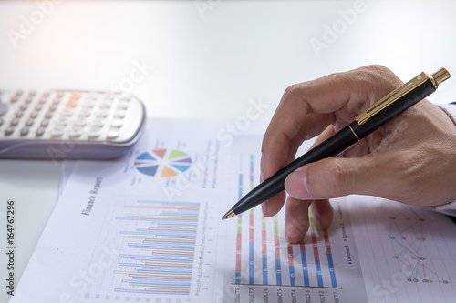 Close up Businessman check seriously analyzes a finance report investor colleagues discussing new plan financial graph. Finance managers task. Concept business and finance ,Account analyzes planing