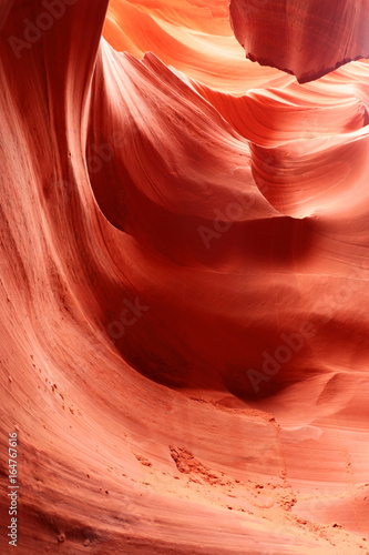 Amazing nature red sandstone textured background. Swirls of old red sandstone wall abstract pattern in Lower Antelope Canyon, Page, Arizona, USA.