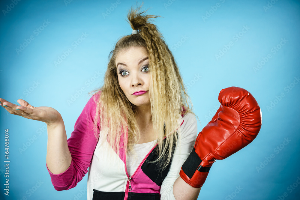Funny confused woman wearing boxing glove Funny confused woman wearing boxing glove