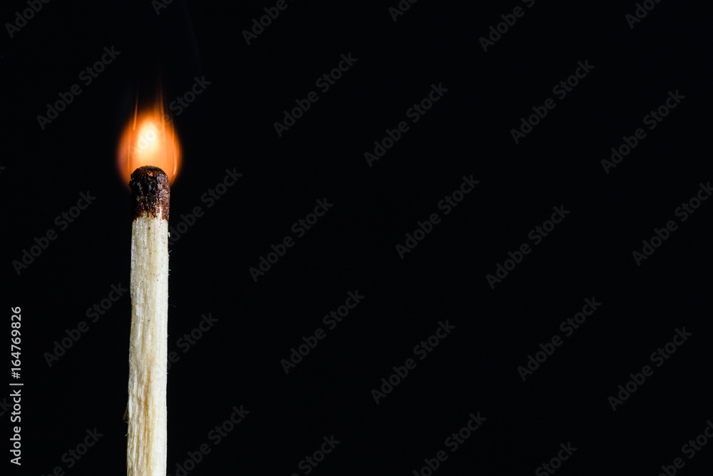 Lonely the flaring match isolated on black background Lonely the flaring match isolated on black background