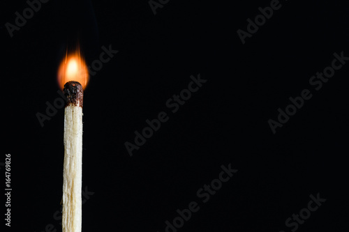 Lonely the flaring match isolated on black background