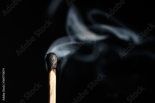 extinguished match liberally let smoke isolated on black background