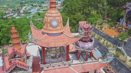 Flycam Shows Red Temple Roof among Buildings Tropical Plants photo