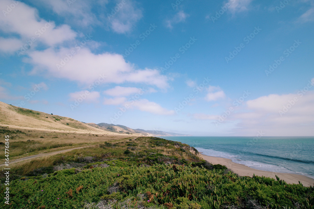 Beach and mountains with clear sky