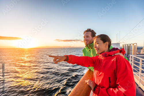 Obraz na płótnie Cruise travel tourists couple pointing at sea view from ferry tour
