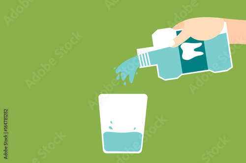 hand pouring mouthwash into glass