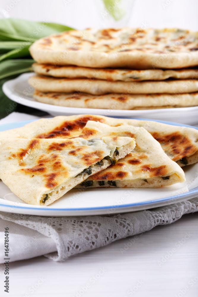 Khychiny – traditional caucasian flatbread filled with сheese and herbs.