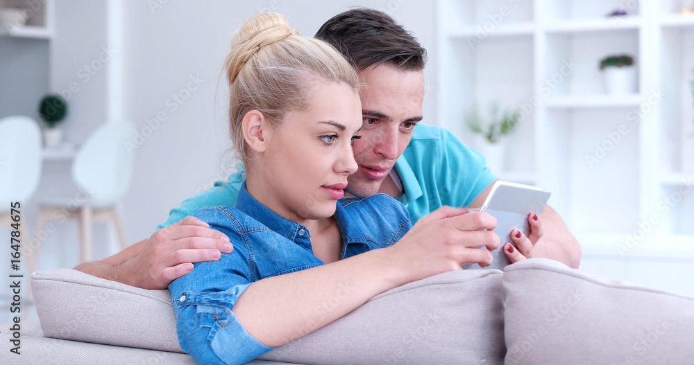 couple relaxing at home with tablet computers couple relaxing at home with tablet computers